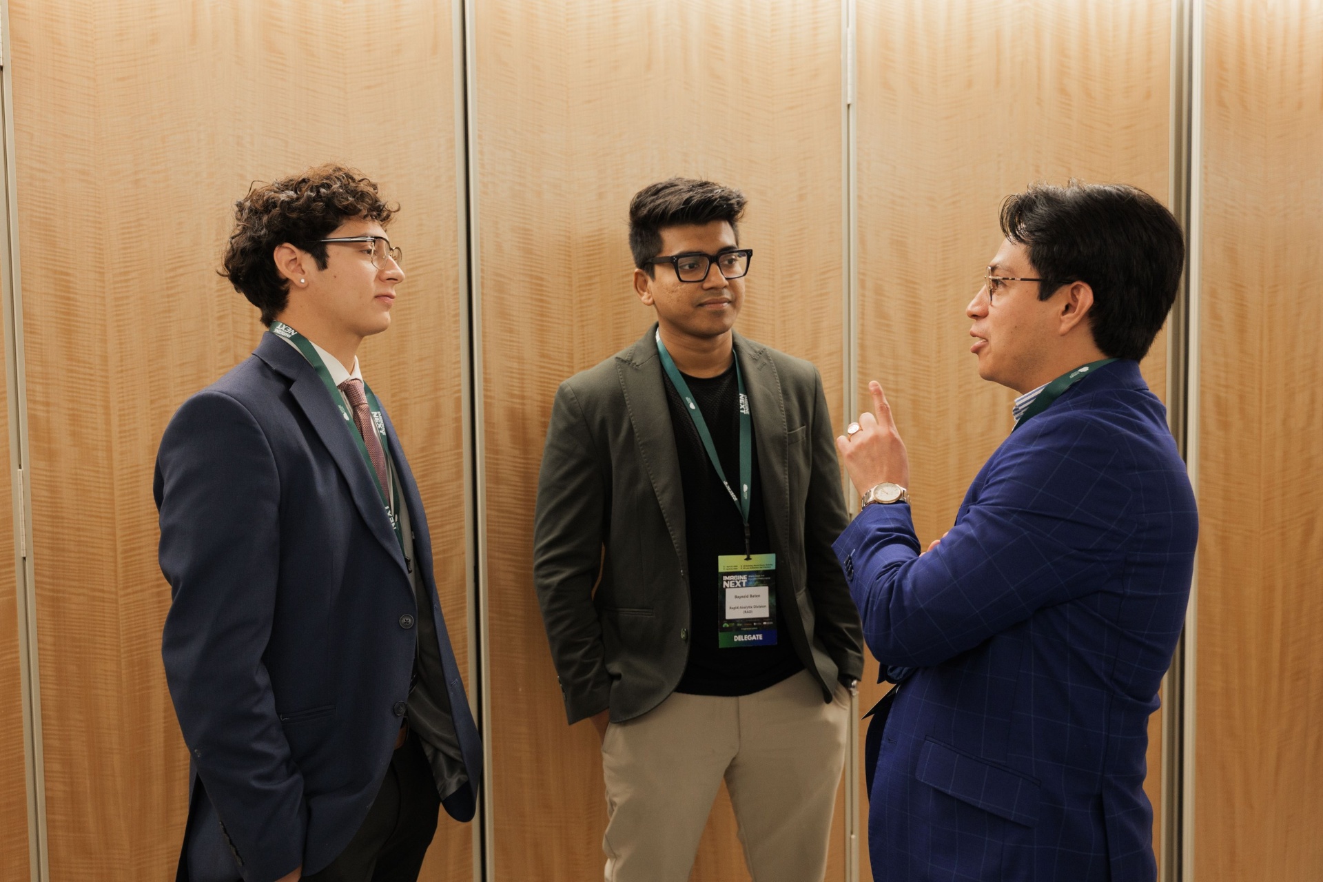 Three Capital Day delegates networking in the UC Law SF foyer between sessions