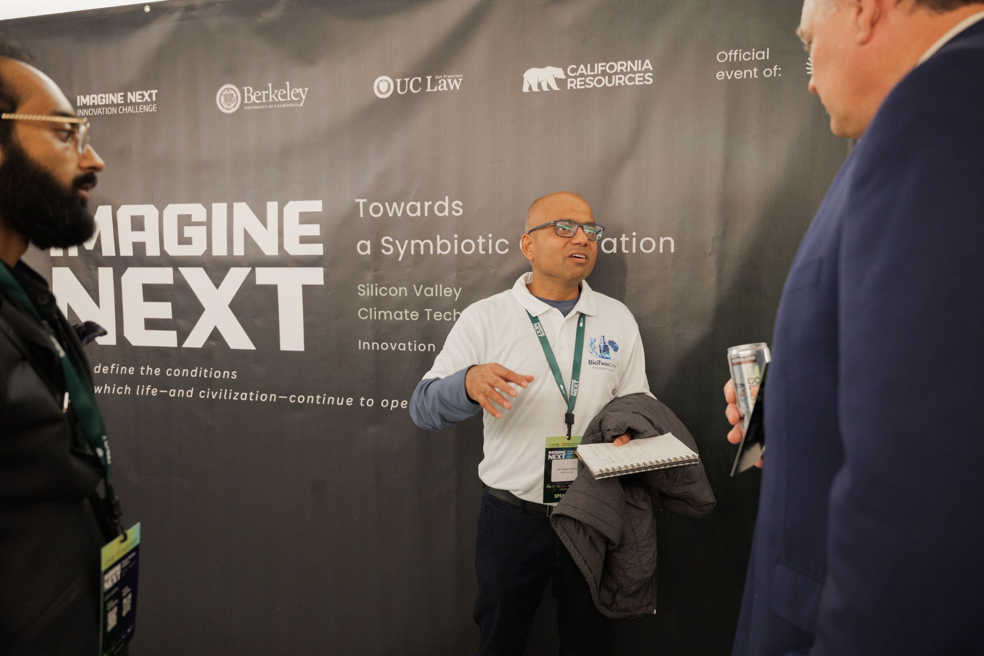 BioTwinOme founder Dr. Manoj Agrawal in conversation with delegates in front of the Imagine Next Capital Day backdrop