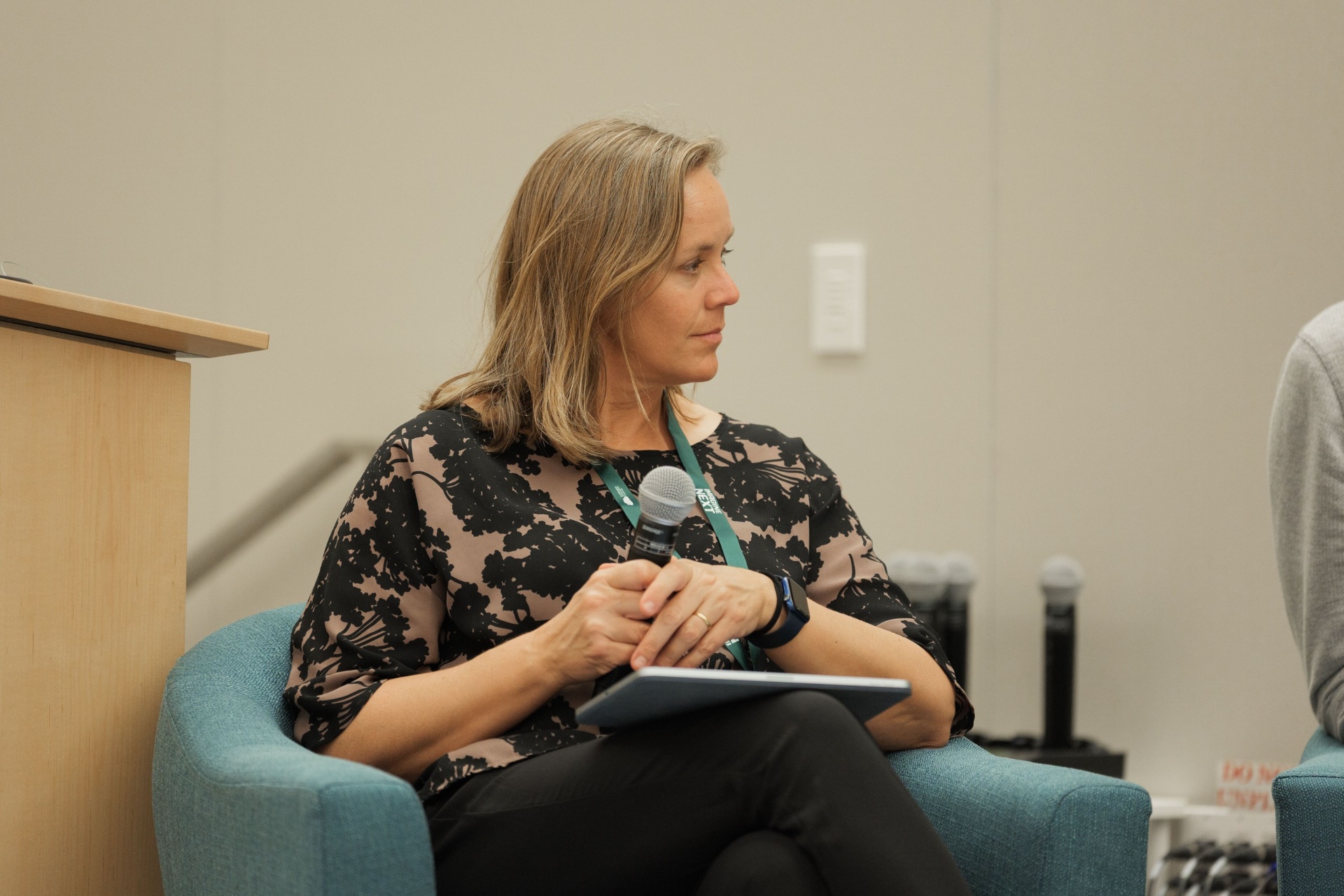 Christina Cairns holding the mic while moderating Capital Day Panel 5 'From Growth to Bankability' at UC Law SF