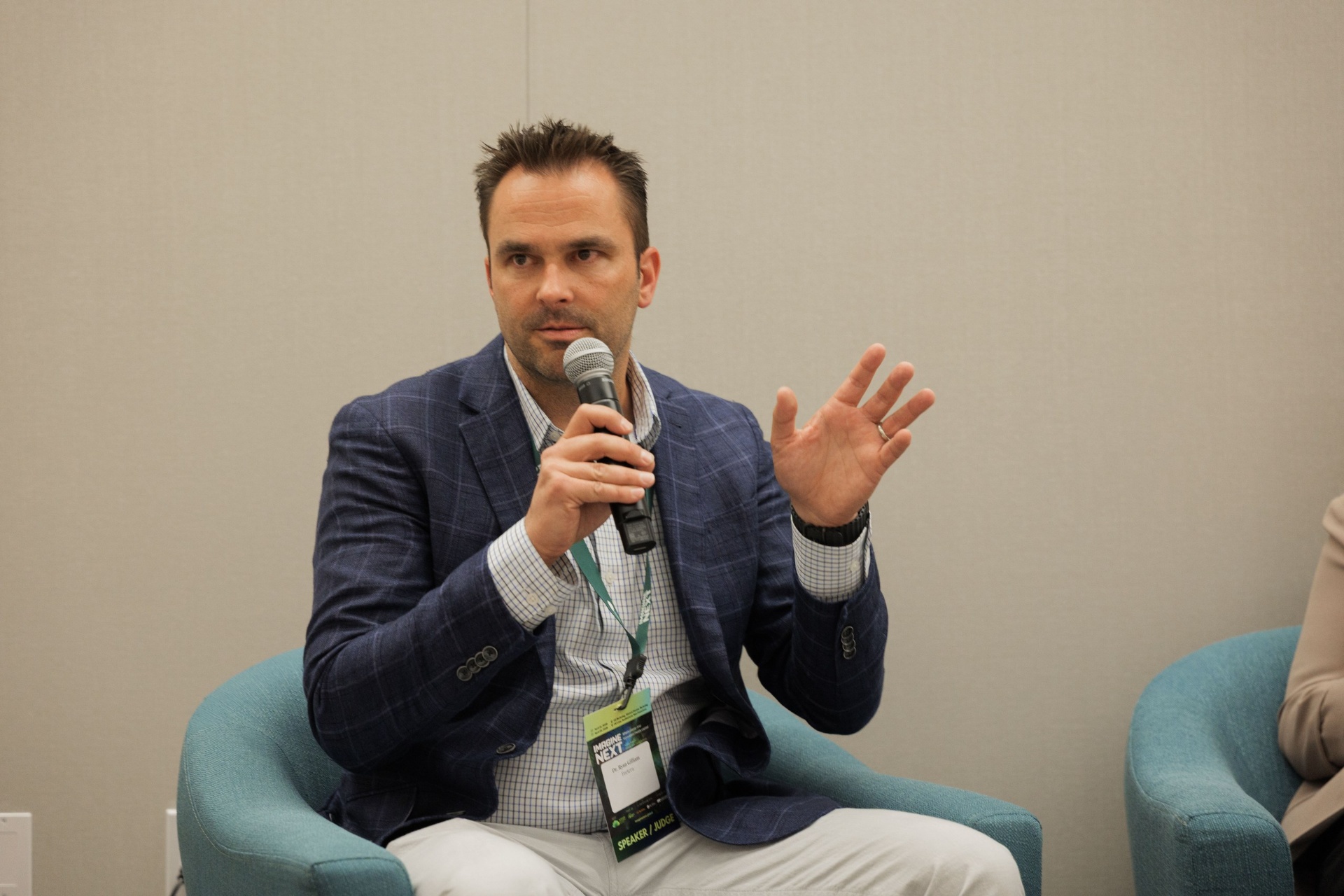 Portrait of Dr. Ryan Gilliam, CEO of Fortera, speaking with mic on the Capital Day fireside chat at UC Law SF