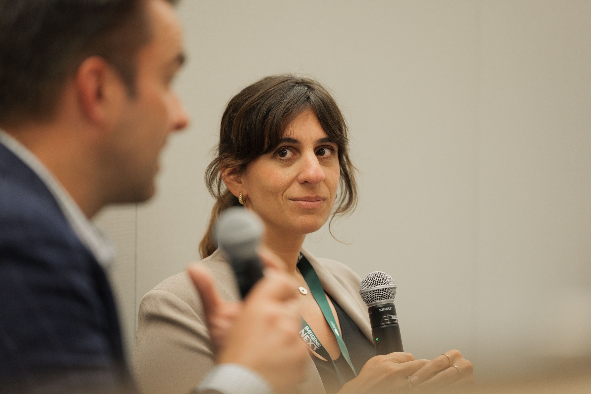 Portrait of Natalie Volpe, Director of Investments at WOLLEMI, listening attentively while moderating the Capital Day fireside chat with Dr. Ryan Gilliam of Fortera