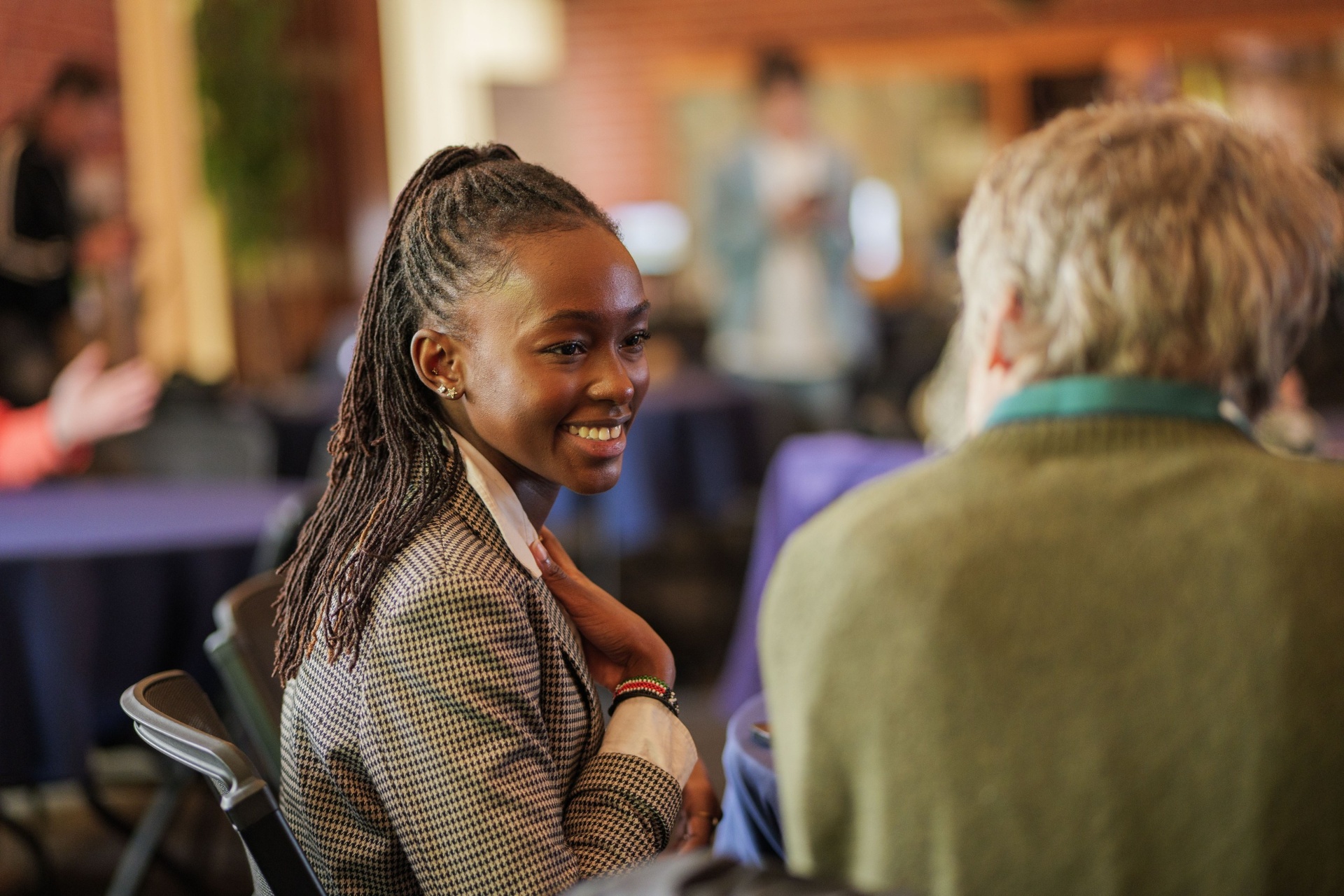 Delegate smiling during a networking conversation