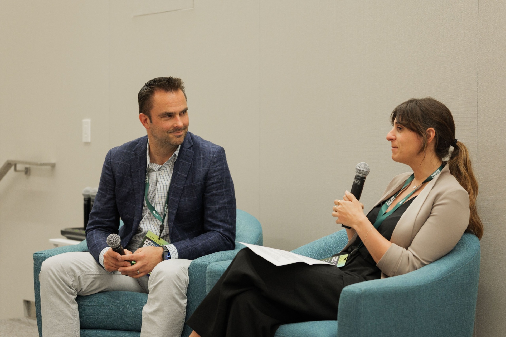 Natalie Volpe, Director of Investments at WOLLEMI, asking a question with mic while Dr. Ryan Gilliam of Fortera listens during the Capital Day fireside chat