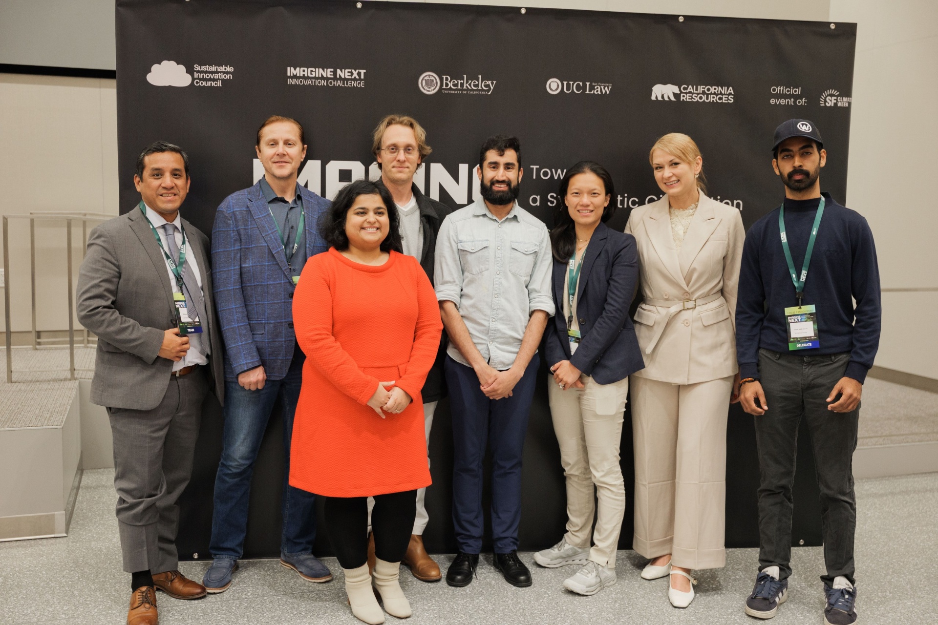Capital Day Panel 4 'Beyond Priced Rounds' group photo at UC Law SF — moderator and panelists with delegate in orange dress beneath the Imagine Next Innovation Challenge backdrop with UC Berkeley, UC Law, California Resources and SF Climate Week sponsor logos
