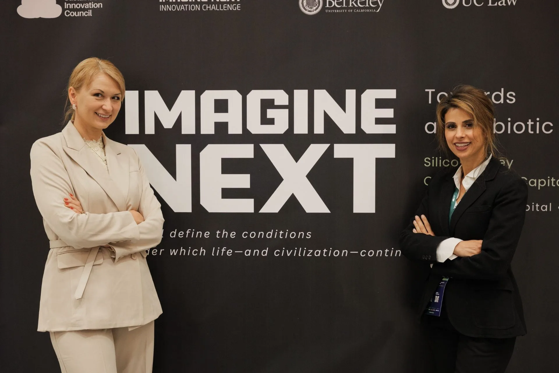Julia Daviy and Mariam Amin JantzSell at the Towards a Symbiotic Civilization backdrop